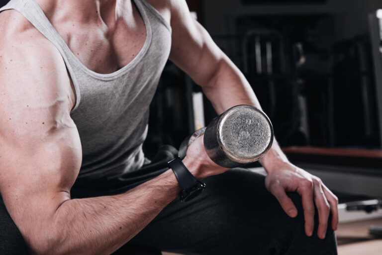 muscular man working out gym doing exercises with dumbbells biceps close up 435174 3895